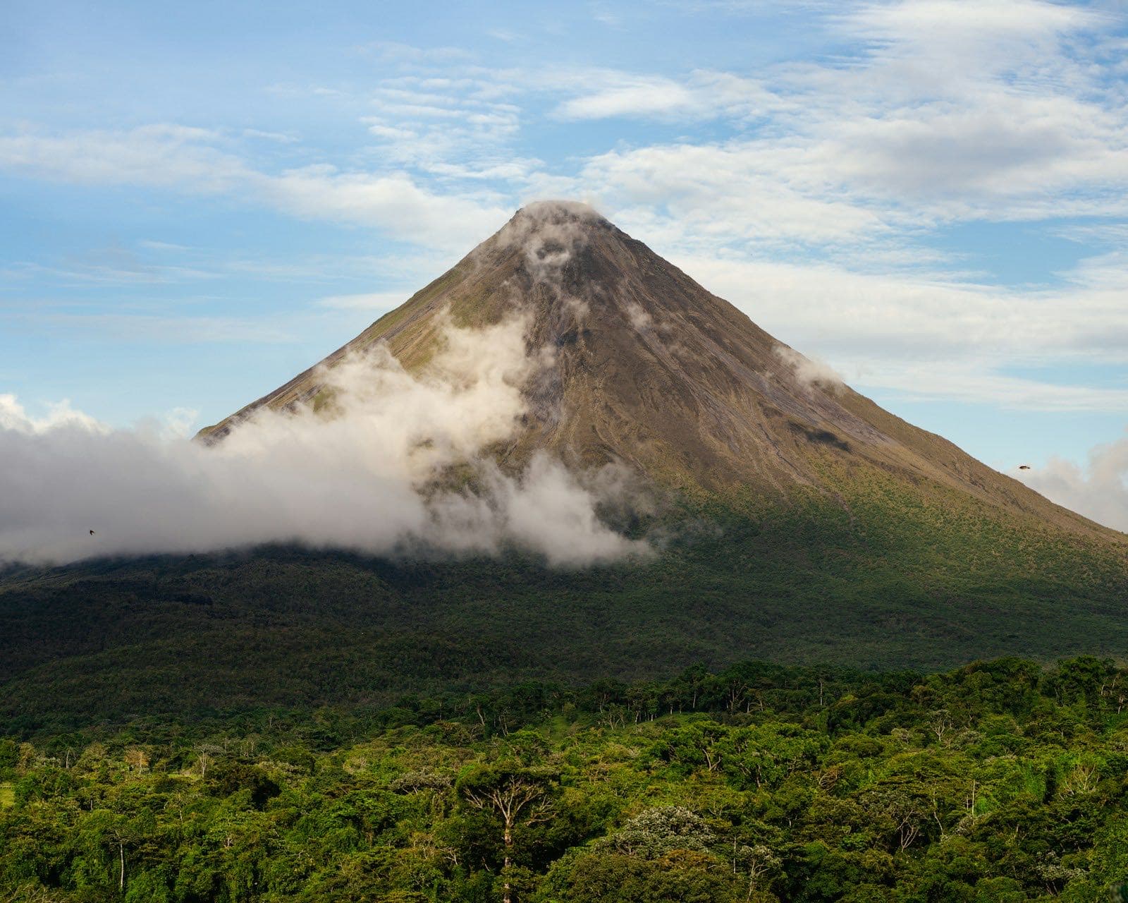 Arenal Volcano rising above the lush Costa Rican rainforest