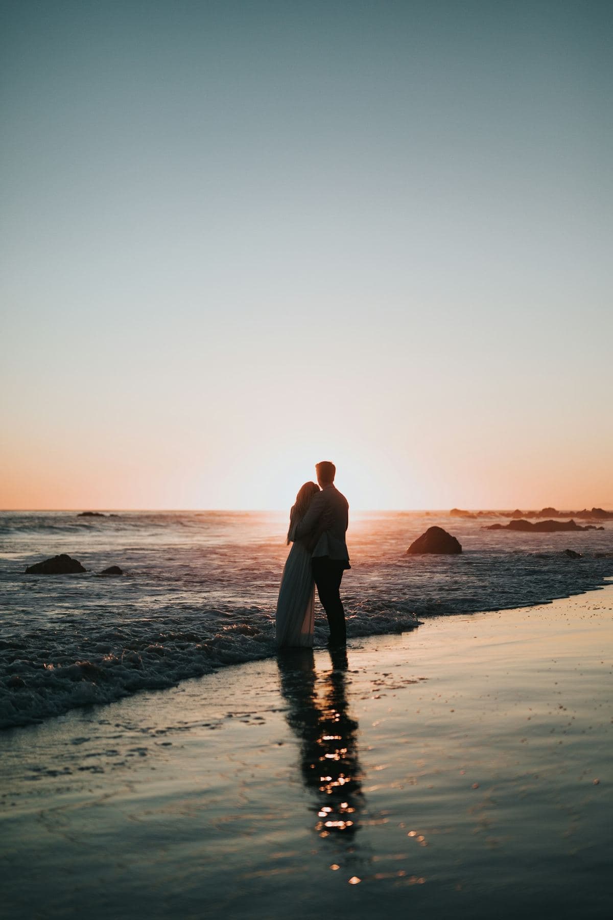 Couple silhouette at sunset on a beach — Costa Rica honeymoon vibe
