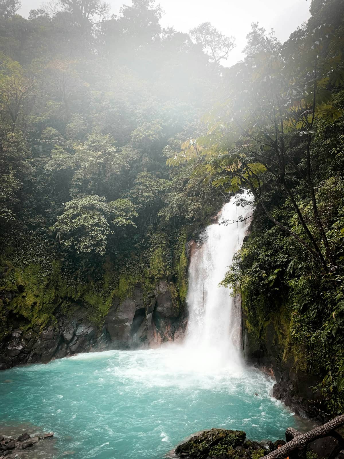 La Fortuna waterfall surrounded by lush rainy-season greenery