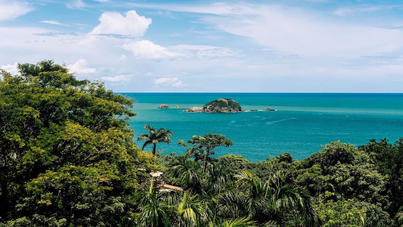 Manuel Antonio's iconic white-sand beach fringed by Pacific jungle and palm trees