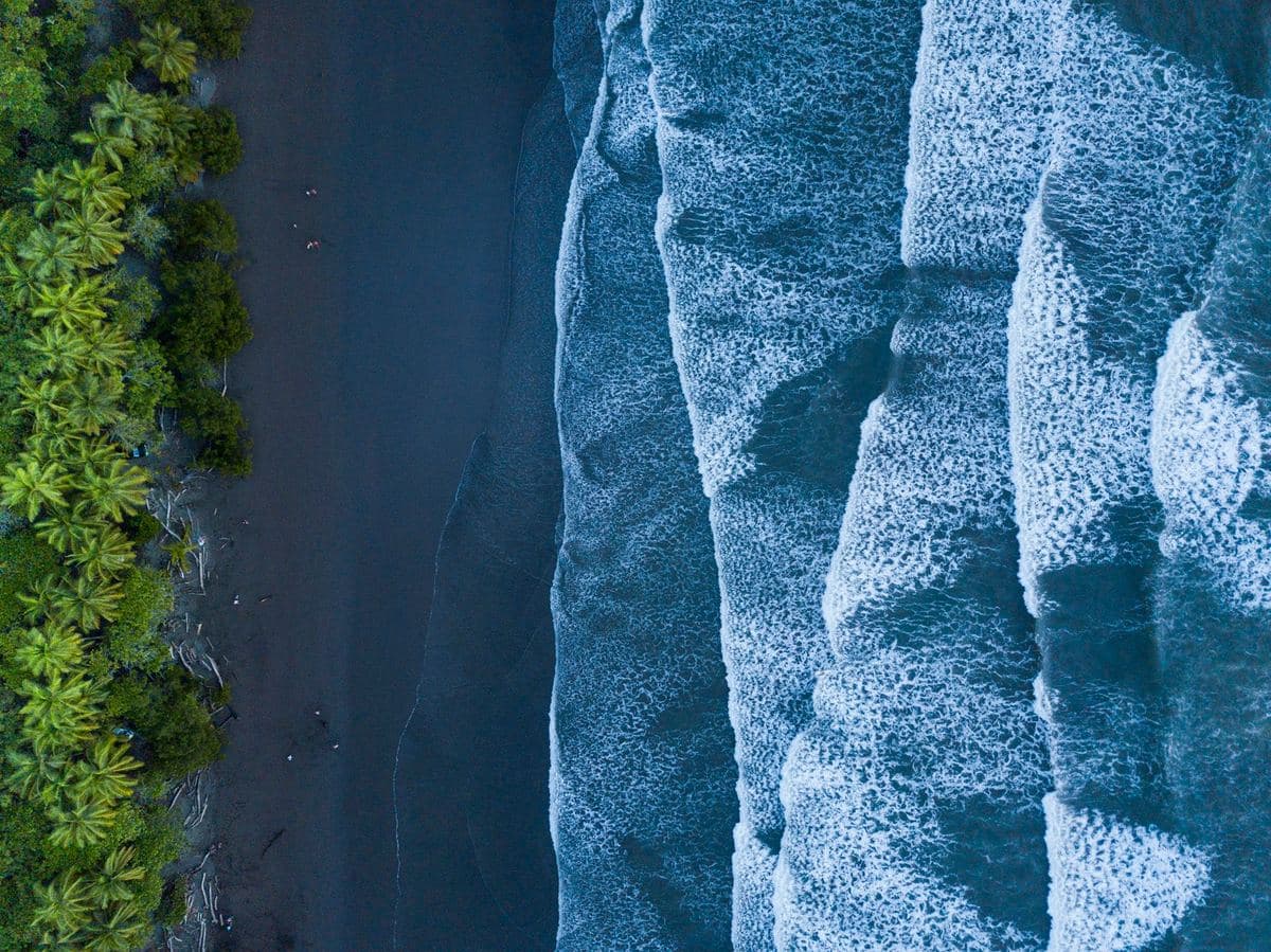 Aerial view of a Costa Rica road winding between forested mountains