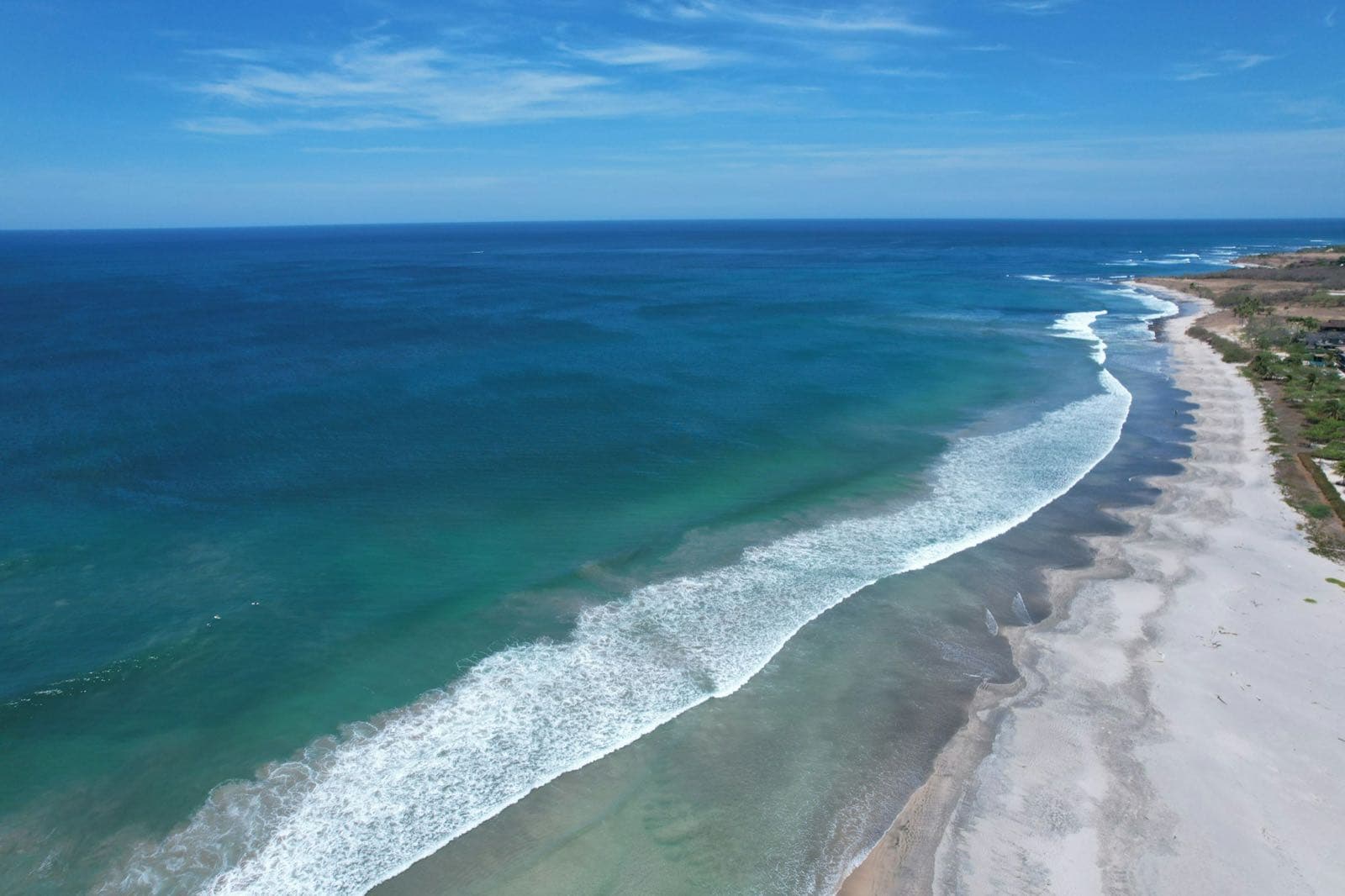 Aerial view of Tamarindo beach in Guanacaste, Costa Rica, with turquoise Pacific surf