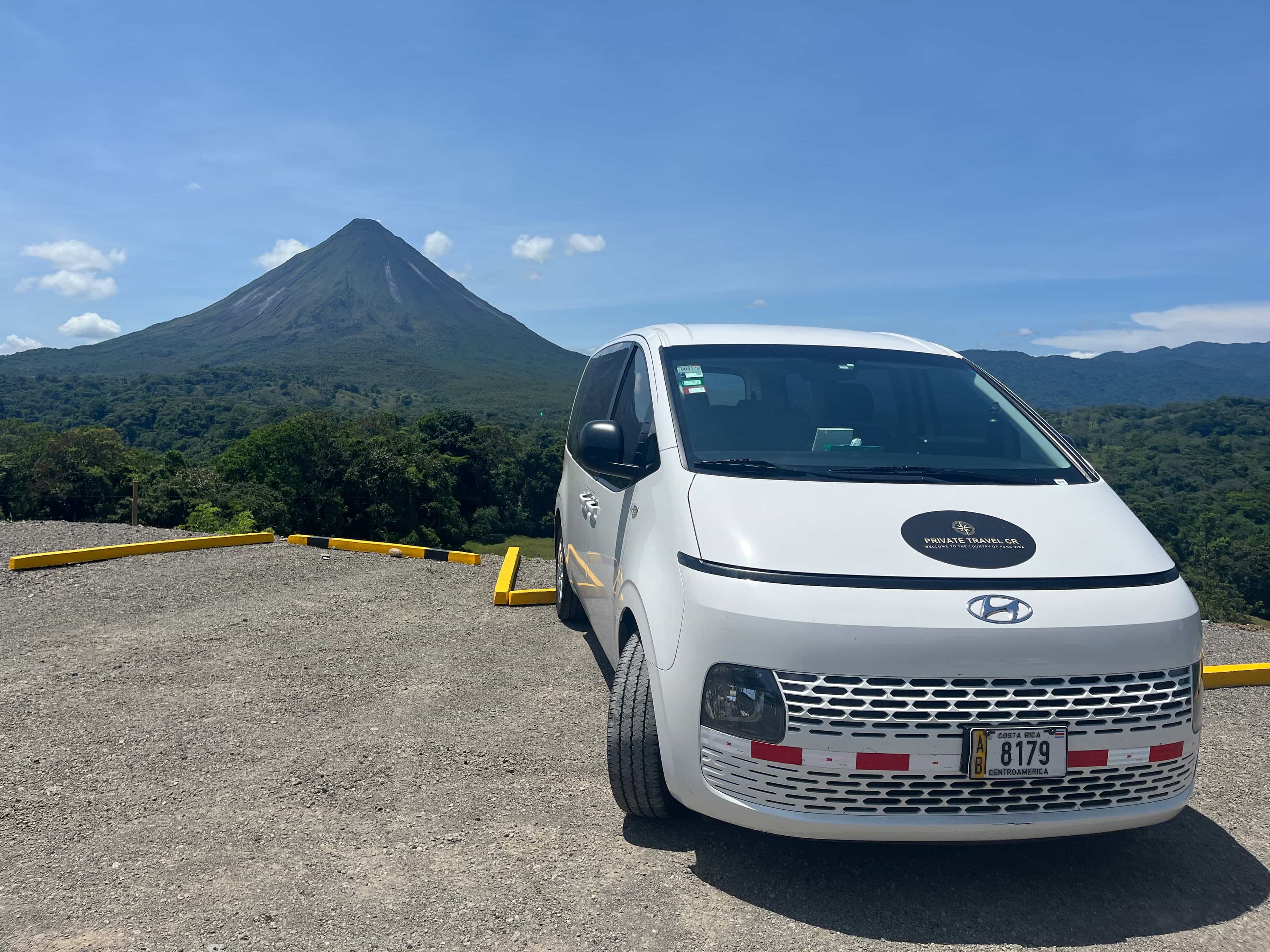 Private Travel CR van parked with the Arenal Volcano behind it in La Fortuna, Costa Rica